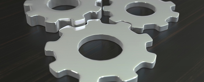 Business composition with metal gears on dark wooden tabletop