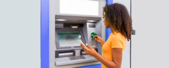 Portrait of young woman using credit card